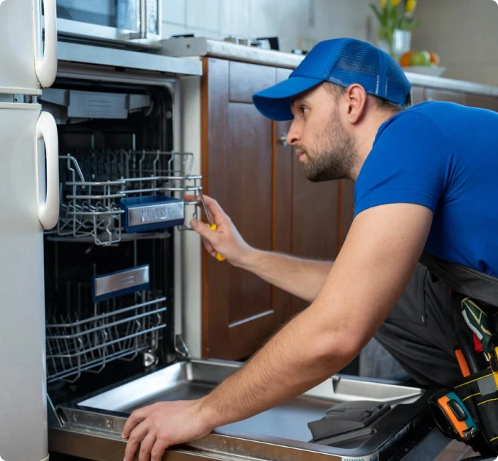 Technician repairing a dishwasher in Abilene, TX