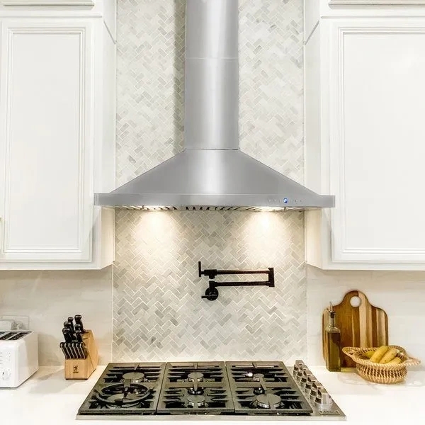 Technician repairing a kitchen exhaust fan and range hood in Abilene, TX